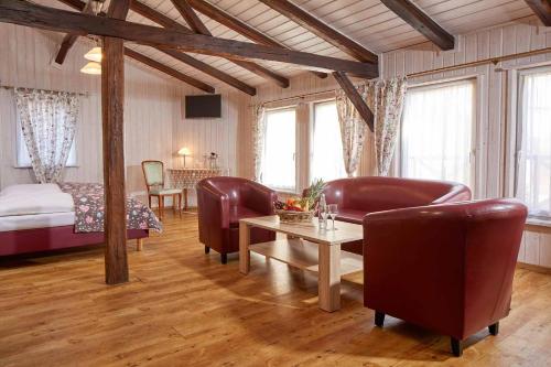 a living room with a bed and a table and chairs at Hotel Eisenbahn in Karlstadt