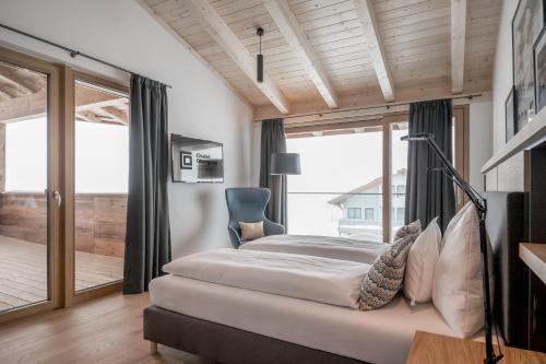a bedroom with a bed and a large window at Chalet Obergurgl Luxury Apartments in Obergurgl
