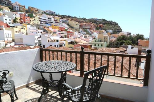a table and chairs on a balcony with a view at Apartamentos Pepita in San Sebastián de la Gomera