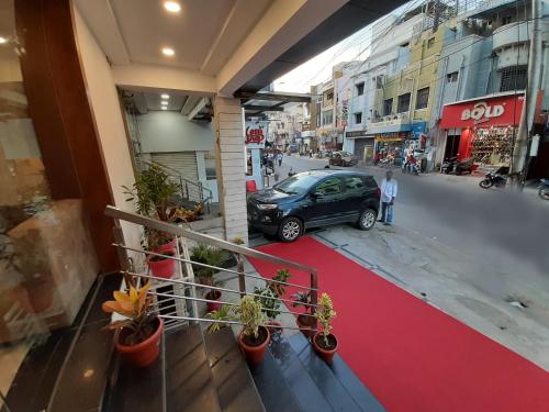 a car parked on a street with a red carpet at Liza Regency in Chennai