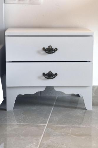 a white dresser with two drawers on it at Studio Galatia, in the heart of Kamilari in Kamilari