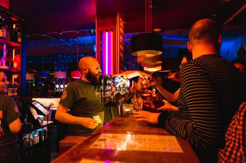 a group of people standing around a bar at Copenhagen Downtown Hostel in Copenhagen