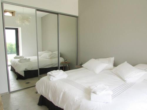 a bedroom with two beds and a large mirror at La Citadelle in Eynesse
