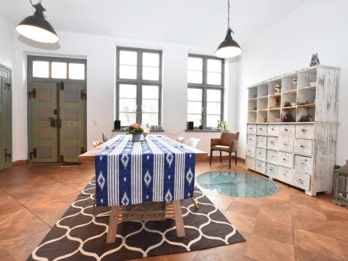 a room with a table with a blue and white table cloth at Ferienhaus in Steffenshagen mit Terrasse in Steffenshagen