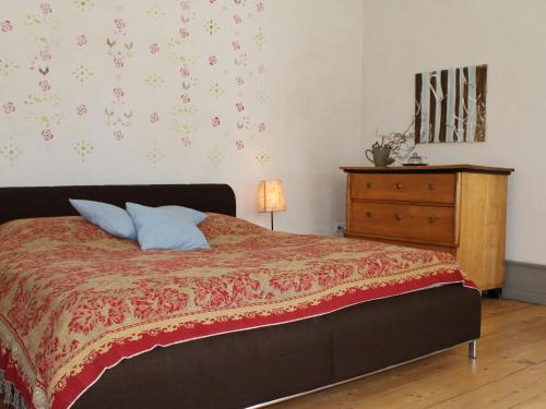 a bedroom with a bed and a dresser in it at Lush Apartment in Steffenshagen with Garden in Steffenshagen