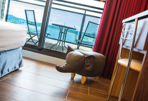 a room with a stuffed elephant chair in front of a window at Sky Young Homestay in Hengchun