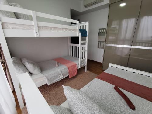 a small room with two bunk beds and a couch at Master Bedroom with toilet in Singapore