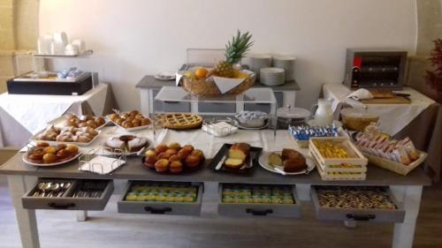 a table topped with lots of different types of food at Aegusa Hotel in Favignana
