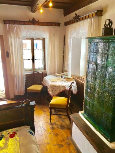 a room with a bedroom with a bed and a window at Count Kálnoky's Transylvanian Guesthouses in Micloşoara