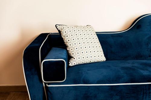 a blue couch with a pillow on top of it at Amadomus Luxury Suites in Naples