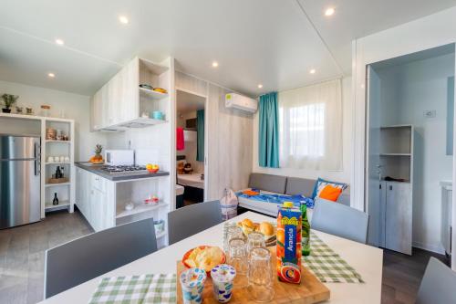a kitchen with a table with food on it at San Benedetto Camping Relais in Peschiera del Garda