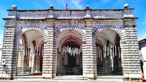 a stone building with three arches on it at Império Romano Guest House in Beja