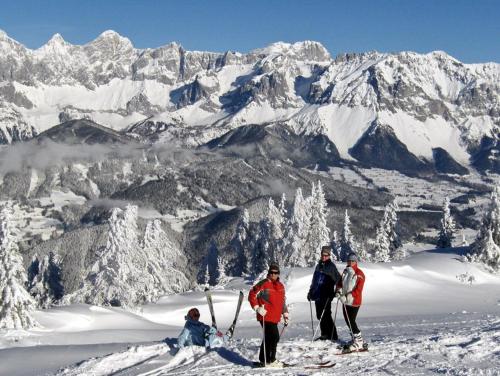 a group of people standing on top of a snow covered mountain at Hotel Jagdhof in Ramsau am Dachstein