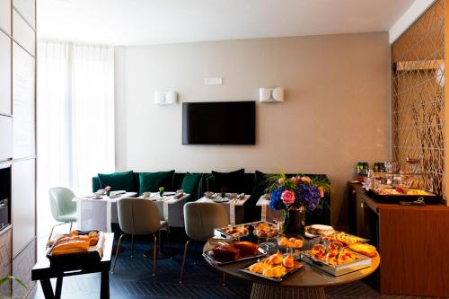 a dining room with a table with food on it at Amadomus Luxury Suites in Naples