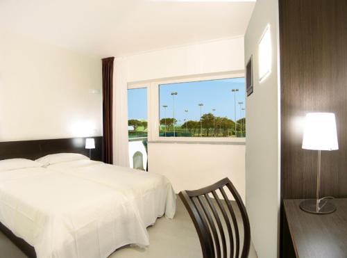 a bedroom with a bed and a table and a window at Ca' Del Moro in Venice-Lido
