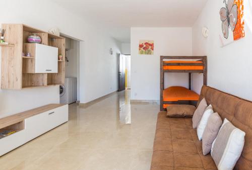 a living room with a couch and a bunk bed at Apartamento Correia in Albufeira