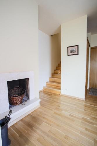 a living room with a fireplace and stairs at Apartments Ameda in Vilnius