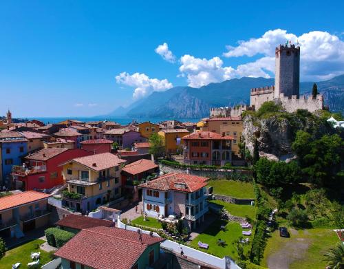 an aerial view of a town with a castle at La Madrugada in Malcesine