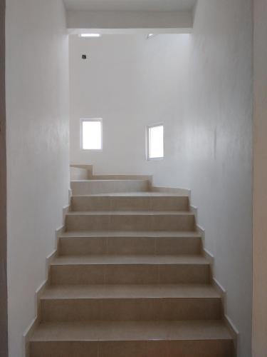 a set of stairs in a building with two windows at HOTEL GOLD in El Oro de Hidalgo