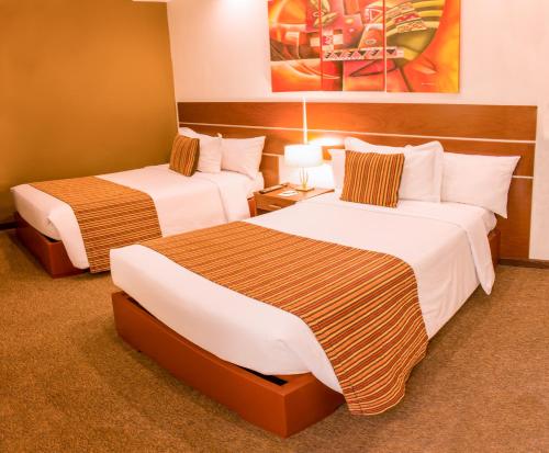 a hotel room with two beds in a room at Hotel La Cuesta de Cayma in Arequipa