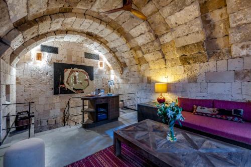a living room with a couch and a fireplace at Carus Cappadocia in Goreme