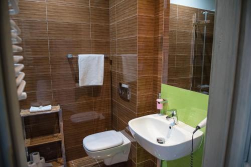 a small bathroom with a sink and a toilet at Apartamenty Faust in Ełk