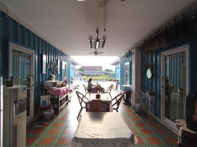 a living room with blue walls and a table at Farsai Homestay in Lop Buri