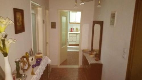 a living room with a table and a mirror at Big apartment near Olympus mountain in Litochoro
