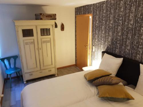 a bedroom with a white bed with pillows on it at Ferienhaus an der Sesselbahn in Cochem