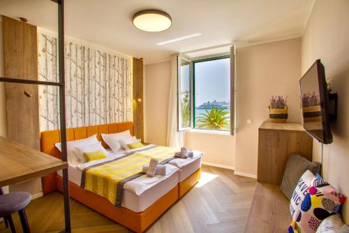 a bedroom with a bed and a window at Apartments & Rooms Grašo in Split