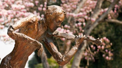 a statue of a girl holding a bat at Stefani Studio Apartman in Opatija