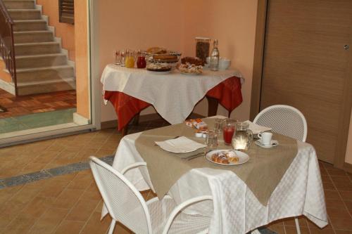 a table with plates of food on top of it at Il Principe B&B in Ali Terme