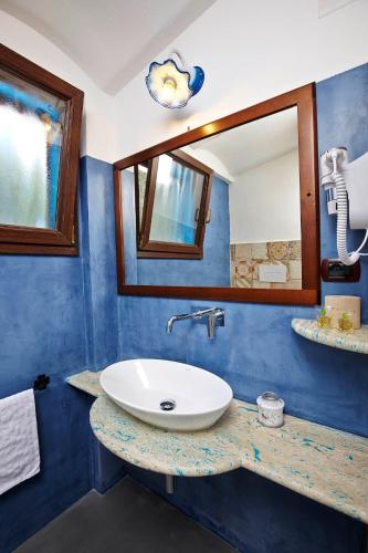 a bathroom with a sink and a mirror at Agriturismo Codula Fuili in Cala Gonone