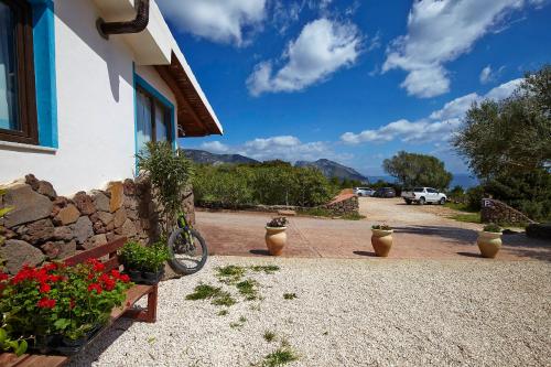 a house with a bike parked next to a building at Agriturismo Codula Fuili in Cala Gonone