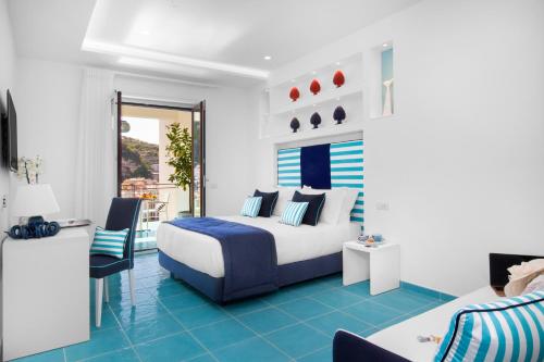 a bedroom with a king sized bed and blue tile floors at Sersale Suites in Sorrento