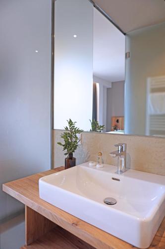 a bathroom with a white sink and a mirror at Mahorko Wein Wellness Wasserbüffel in Glanz an der Weinstraße 
