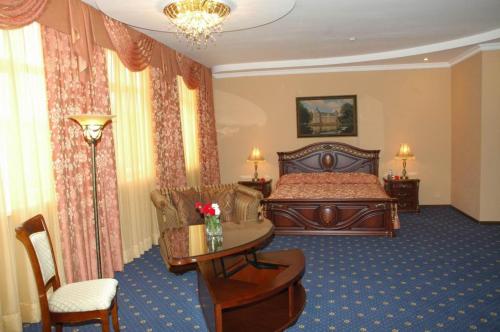 a hotel room with a bed and a table at GK Grand-Hotel in Kislovodsk
