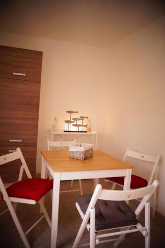a dining room table with two chairs and a table at FeWo Düver in Loxstedt