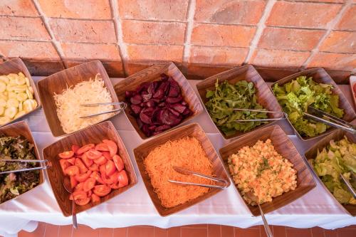 a table topped with bowls of different types of vegetables at El Mirador Hotel & Spa in Colonia del Sacramento