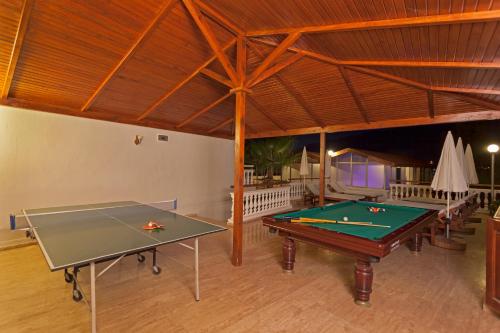 a room with two ping pong tables in a building at Sunny Hill Alya Hotel in Alanya