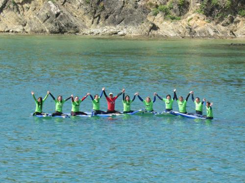 a group of people in a row team on the water at Casa en primera linea de playa en Pantin!! in Pantín