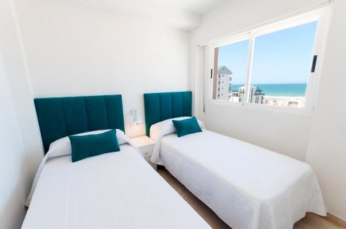 Postel nebo postele na pokoji v ubytování Calmo Singular Apartments
