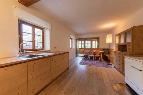 a large kitchen with a sink and a table at Wassermann in Sesto