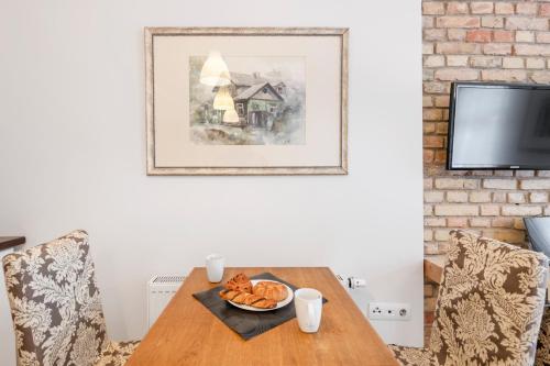 a dining room table with a plate of food on it at Vilnius Apartments in Vilnius