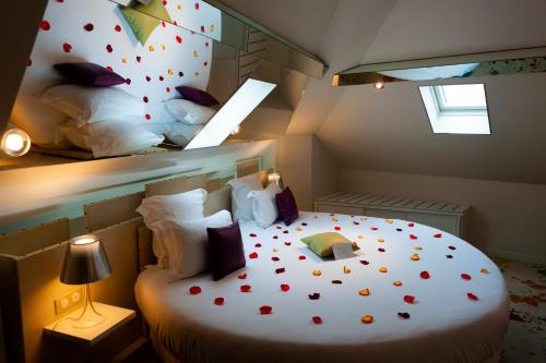 a bedroom with a bed with red hearts on it at Secret de Paris - Hotel & Spa in Paris
