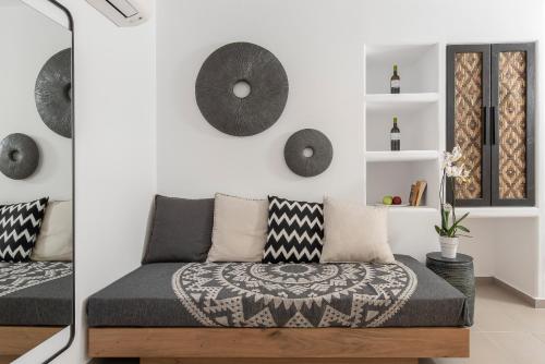 a living room with a couch and artwork on the wall at Little Venice Villas in Mýkonos City
