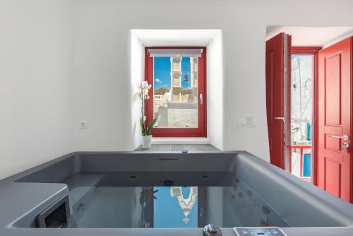 a kitchen with a glass counter top and a window at Little Venice Villas in Mýkonos City