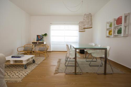 a living room with a table and chairs at The Minimal House II in Bombarral