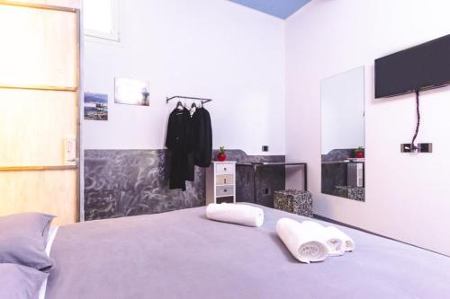 a bedroom with a bed with towels on it at A CASA DI MARIANNA in Ravenna