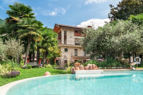 a swimming pool in front of a house at Da Gianni e Villa Annamaria in Arco